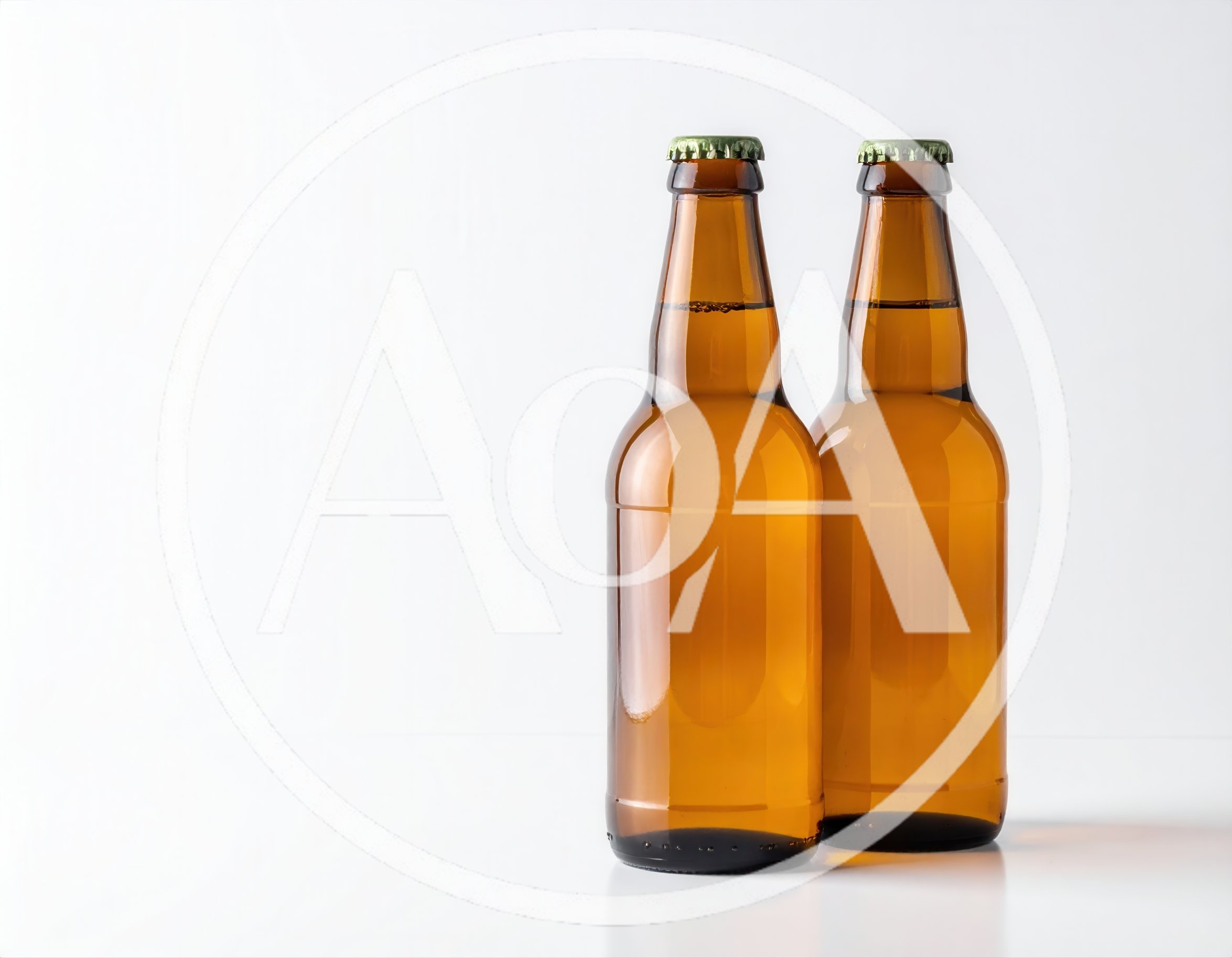 Two Amber Glass Beer Bottles On White Background