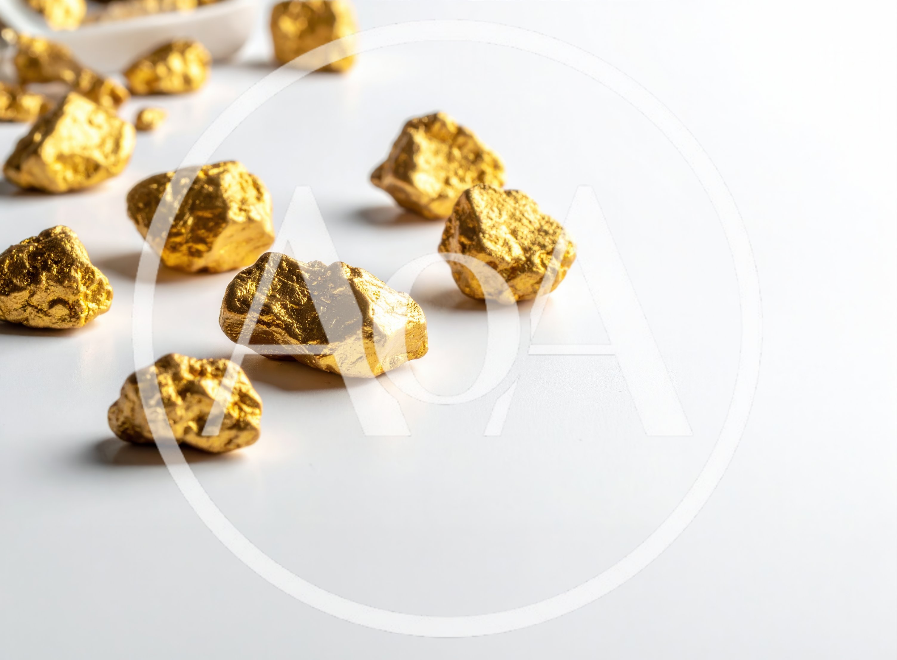 Scattered Gold Nuggets on a White Surface