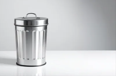 Stainless Steel Trash Can On White Surface