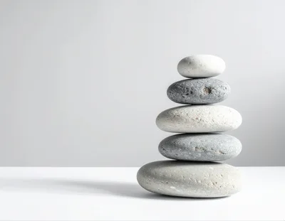 Stacked Smooth River Stones On White Surface