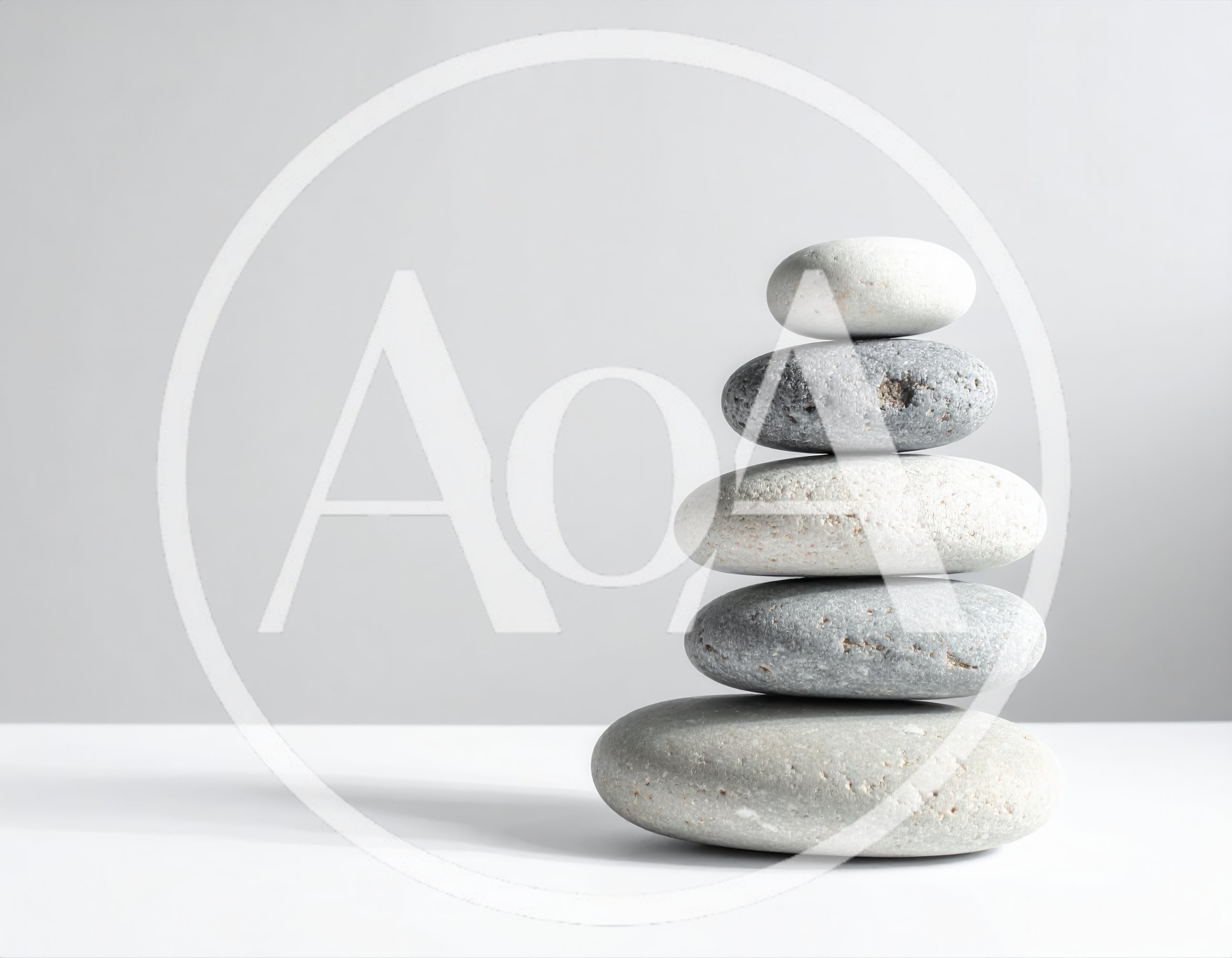 Stacked Smooth River Stones On White Surface