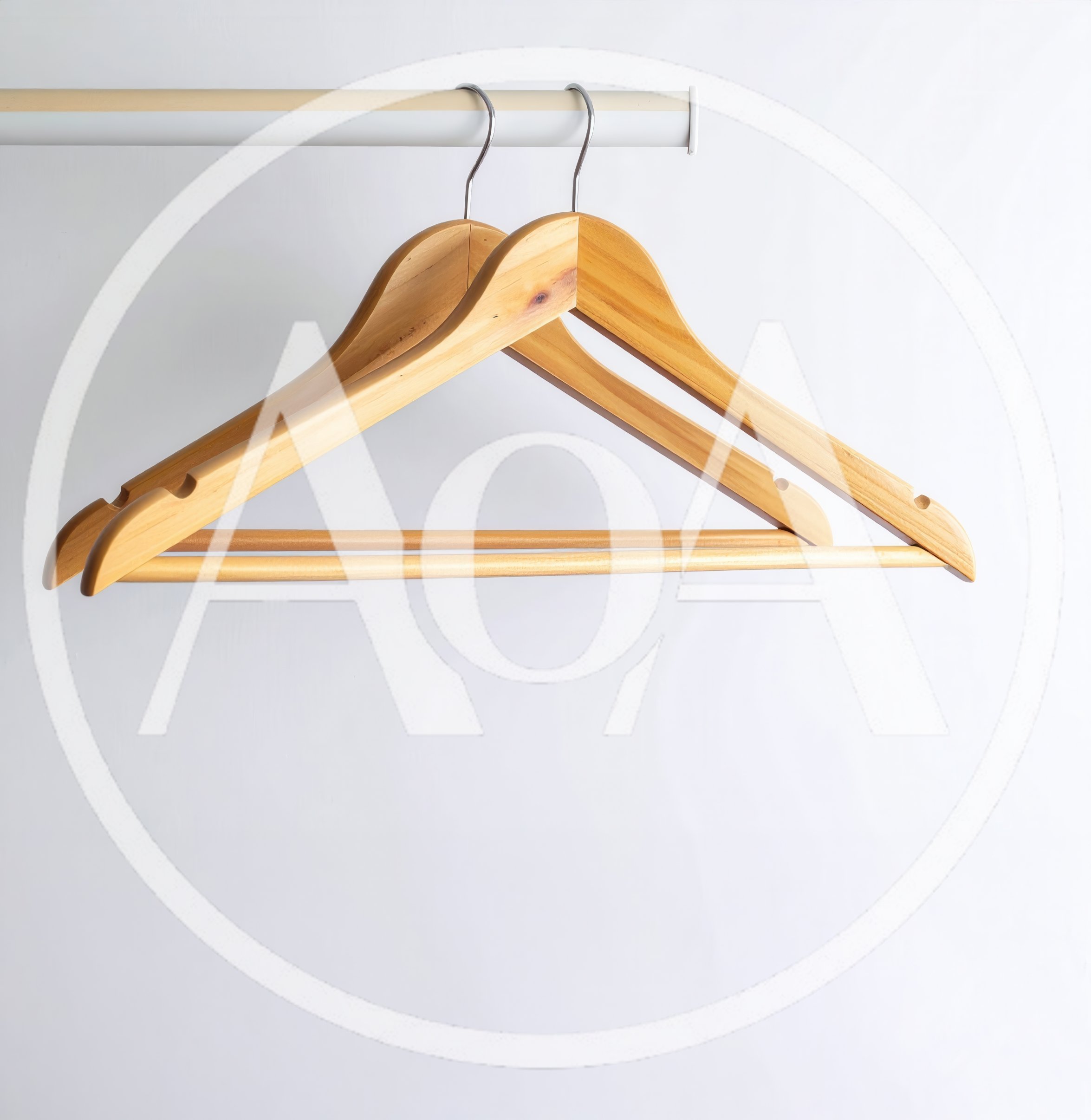 Two Wooden Clothes Hangers Hanging On A Rod