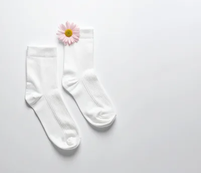 Pair Of White Socks With A Pink Daisy