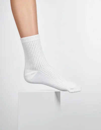 Person Wearing White Ribbed Cotton Sock