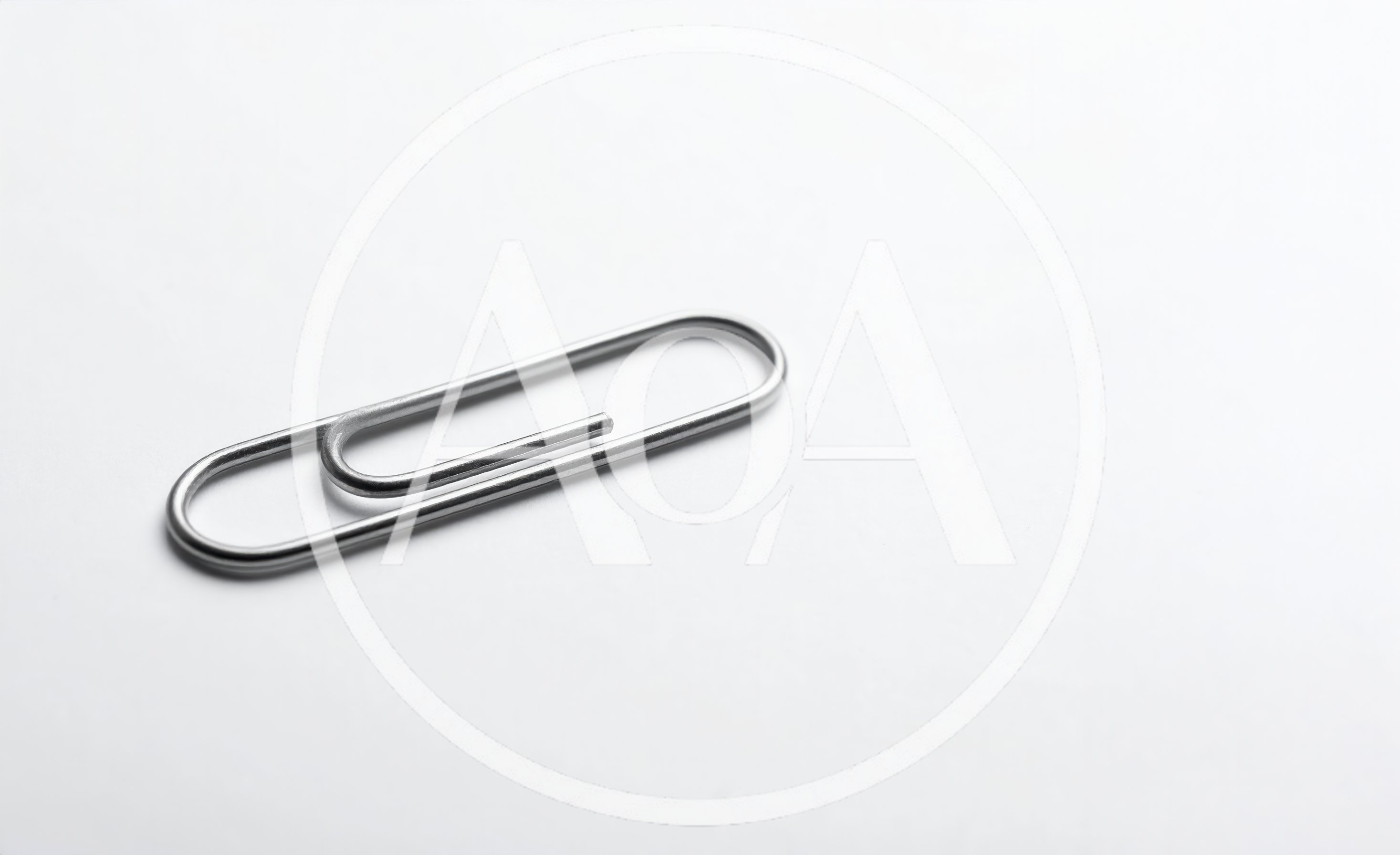 Single Silver Metal Paperclip On White Background