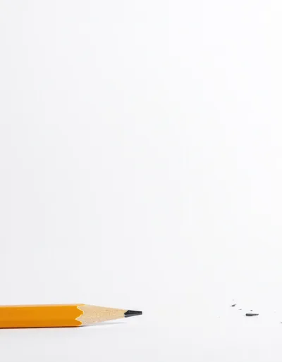 Yellow Pencil With Graphite Shavings On White Background