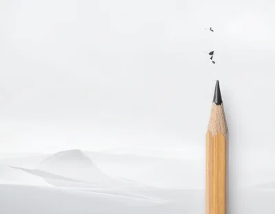 Sharpened Wooden Pencil Against White Paper Background