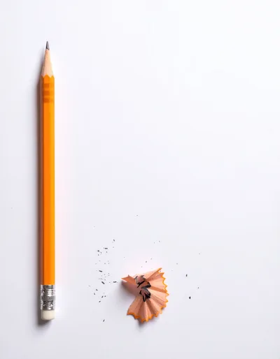 Yellow Pencil With Wood Shavings On White Background