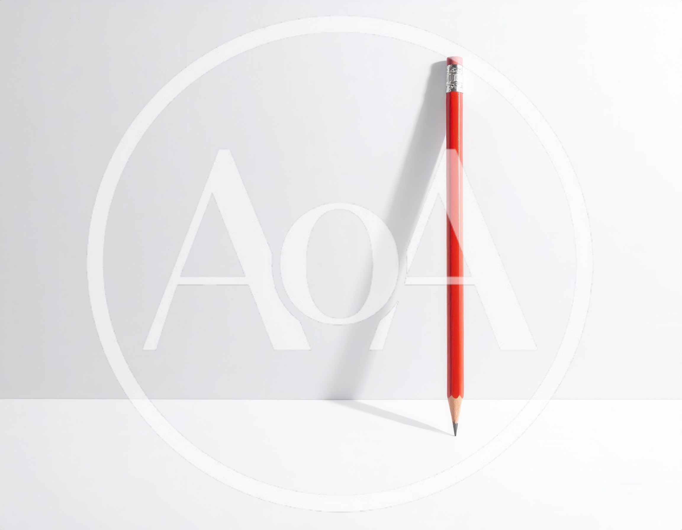 Red Pencil Standing Vertically on White Surface