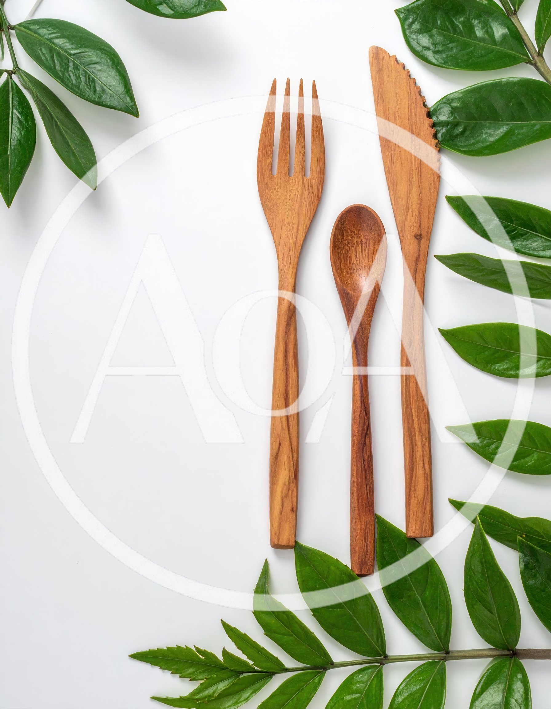 Wooden Cutlery Set With Green Leaves On White Background