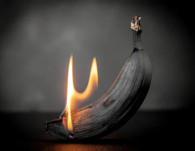 Charred Banana Burning With Bright Orange Flames