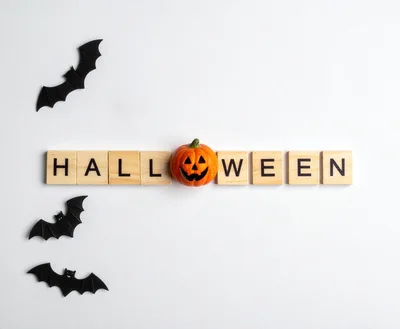 Halloween Word Spelled With Wooden Tiles And Pumpkin