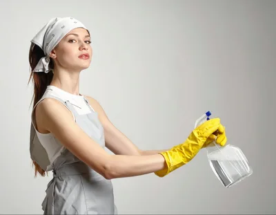 Young Woman Wearing Cleaning Apron And Yellow Gloves