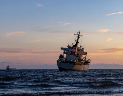 Stranded Cargo Ship Listing Heavily at Sunset