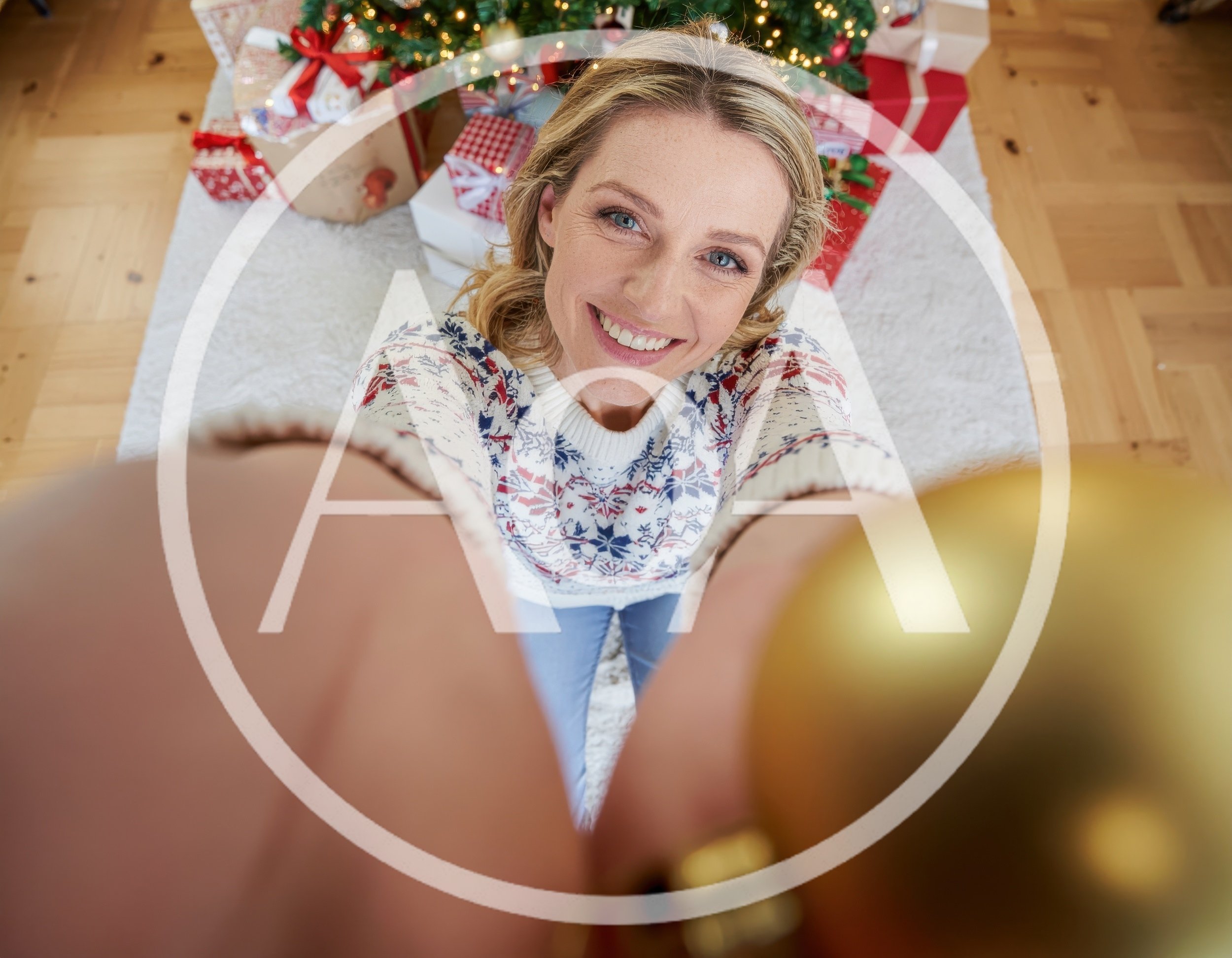 Woman Holding Christmas Ornament Towards Camera