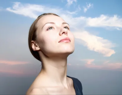 Young Woman Looking Up At The Sky