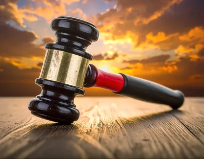 Wooden Judge Gavel Resting On A Rustic Table