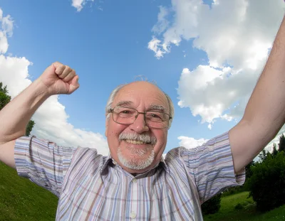 Happy Senior Man Celebrating Success Outdoors