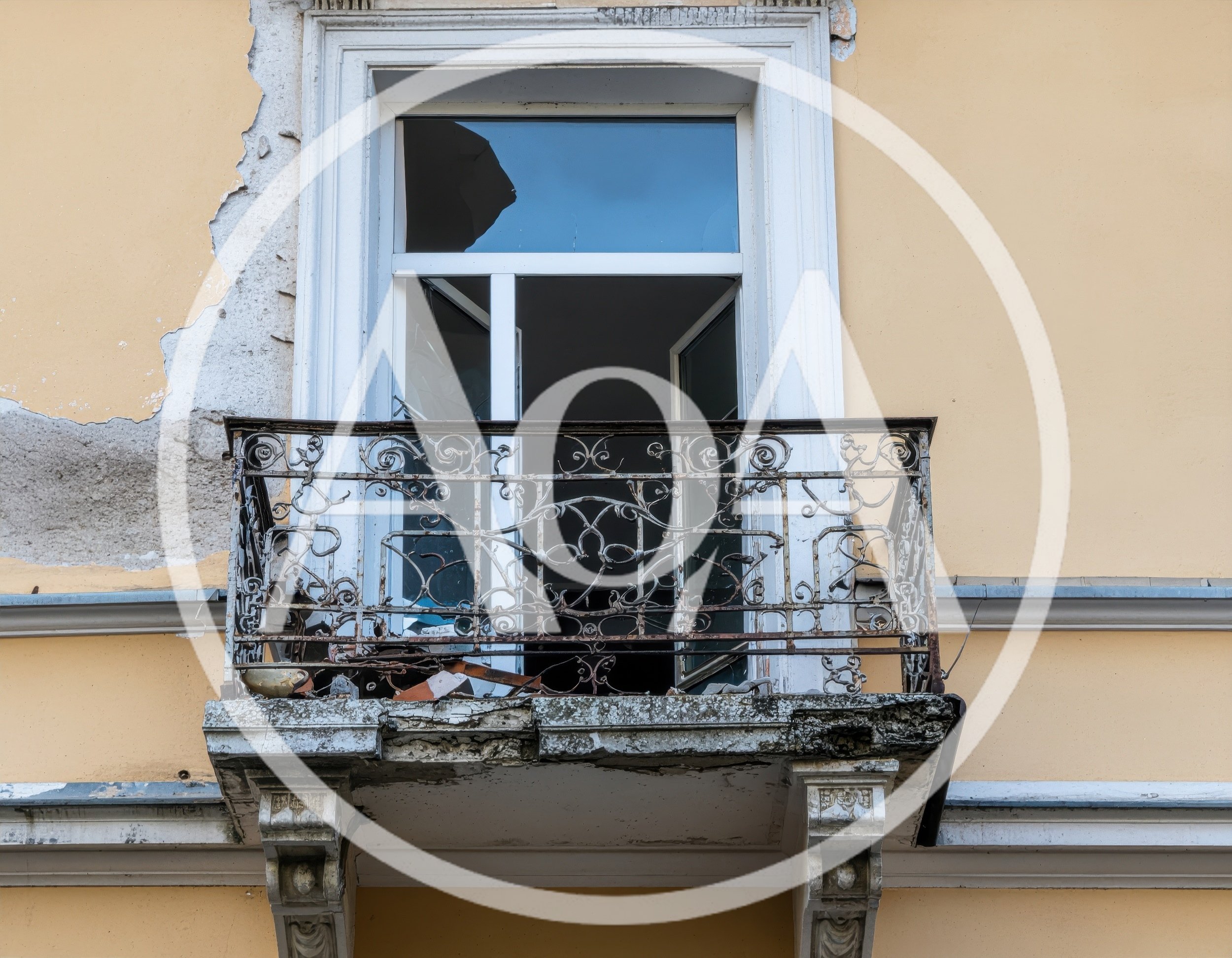 Dilapidated Balcony With Wrought Iron Railing On Old Building