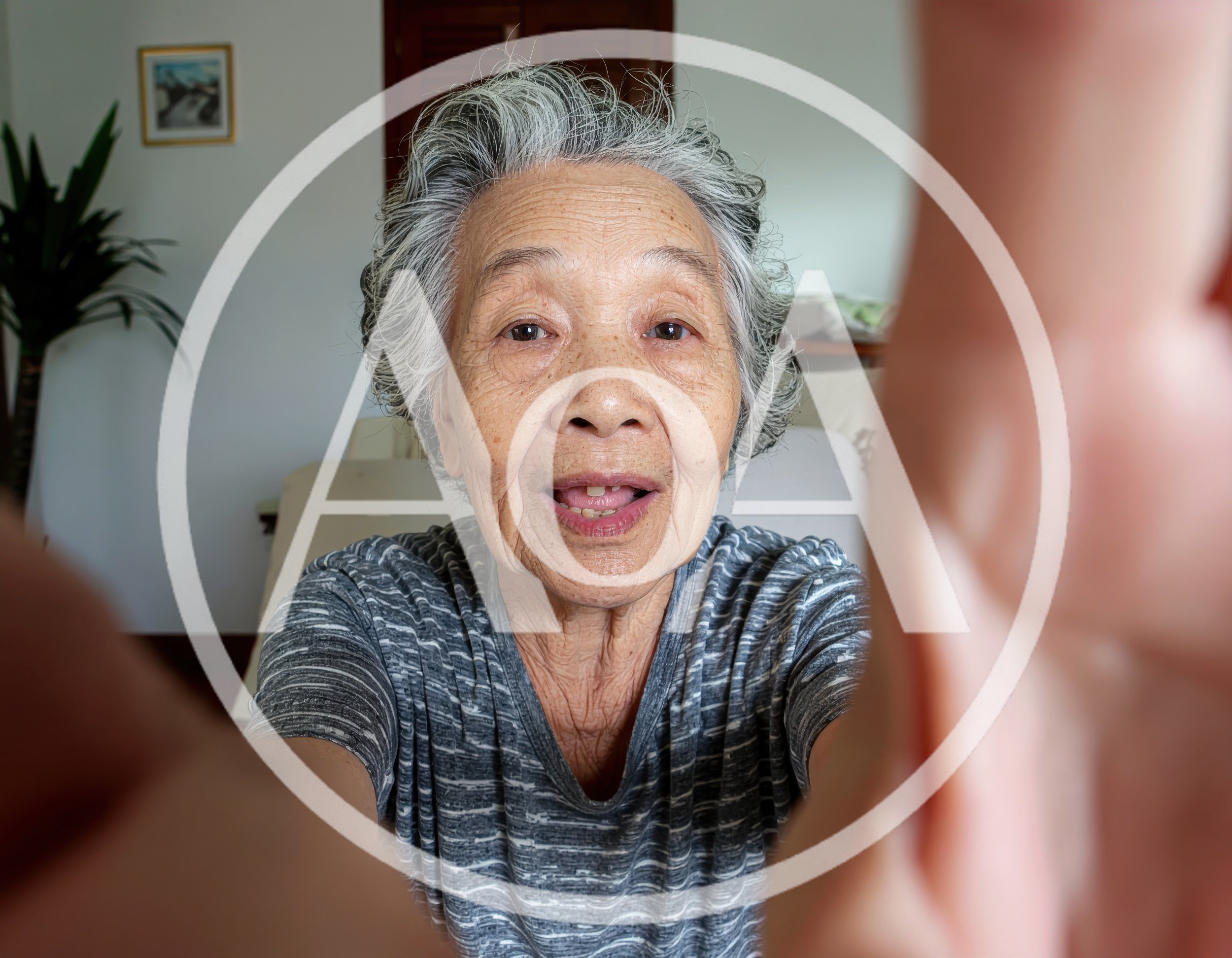 Elderly Asian Woman Taking A Selfie At Home