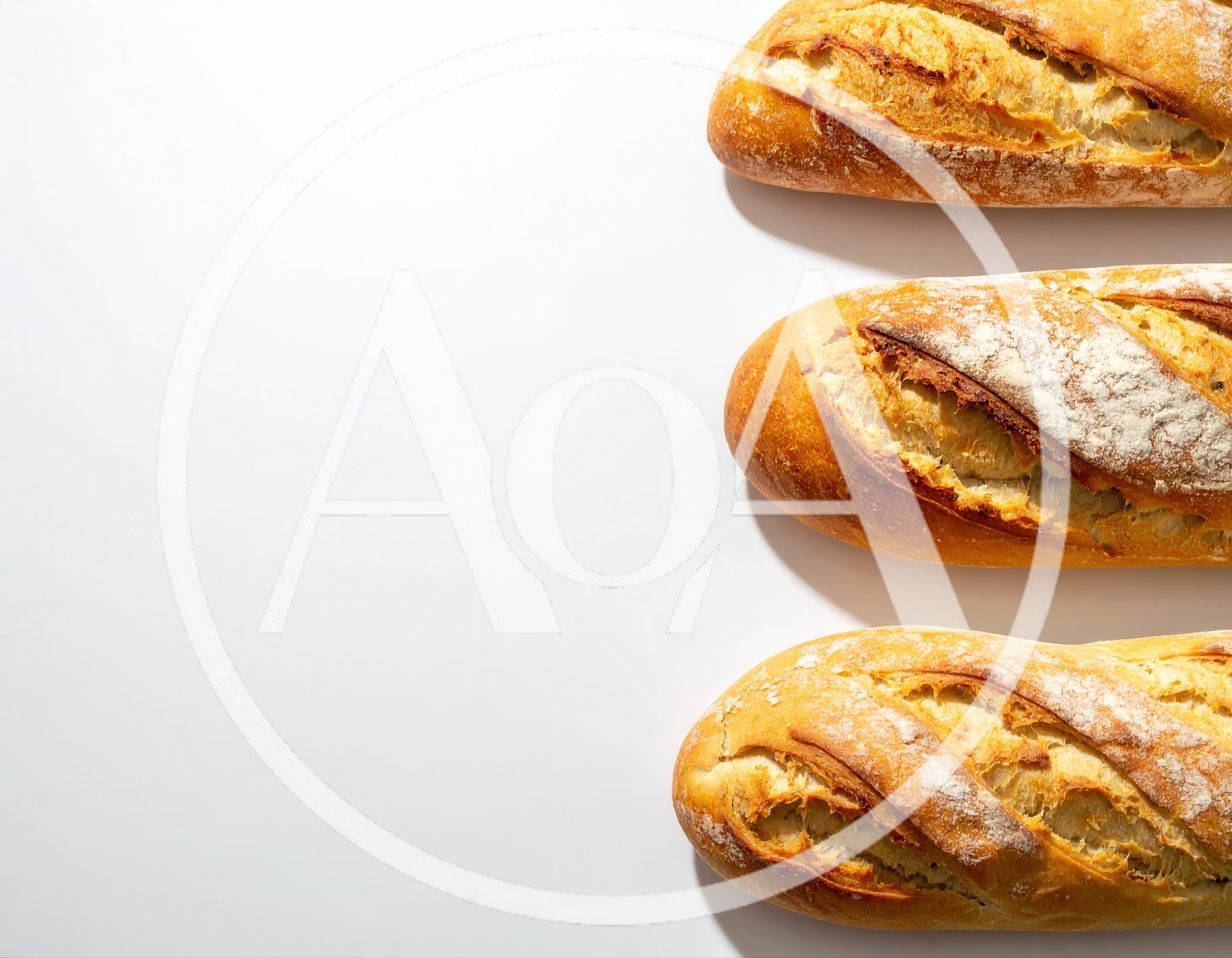 Three Freshly Baked French Baguettes On White Background