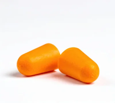 Two Orange Foam Earplugs On White Background