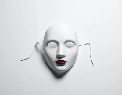 White Face Mask With Red Lips On White Background
