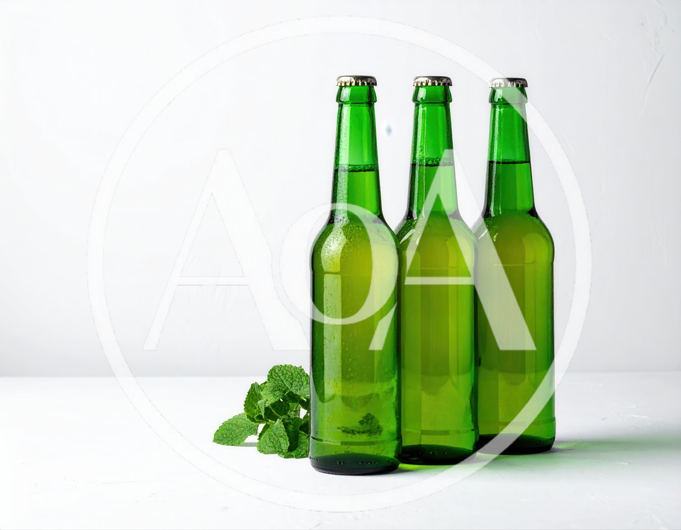 Three Green Glass Beer Bottles With Mint Leaves