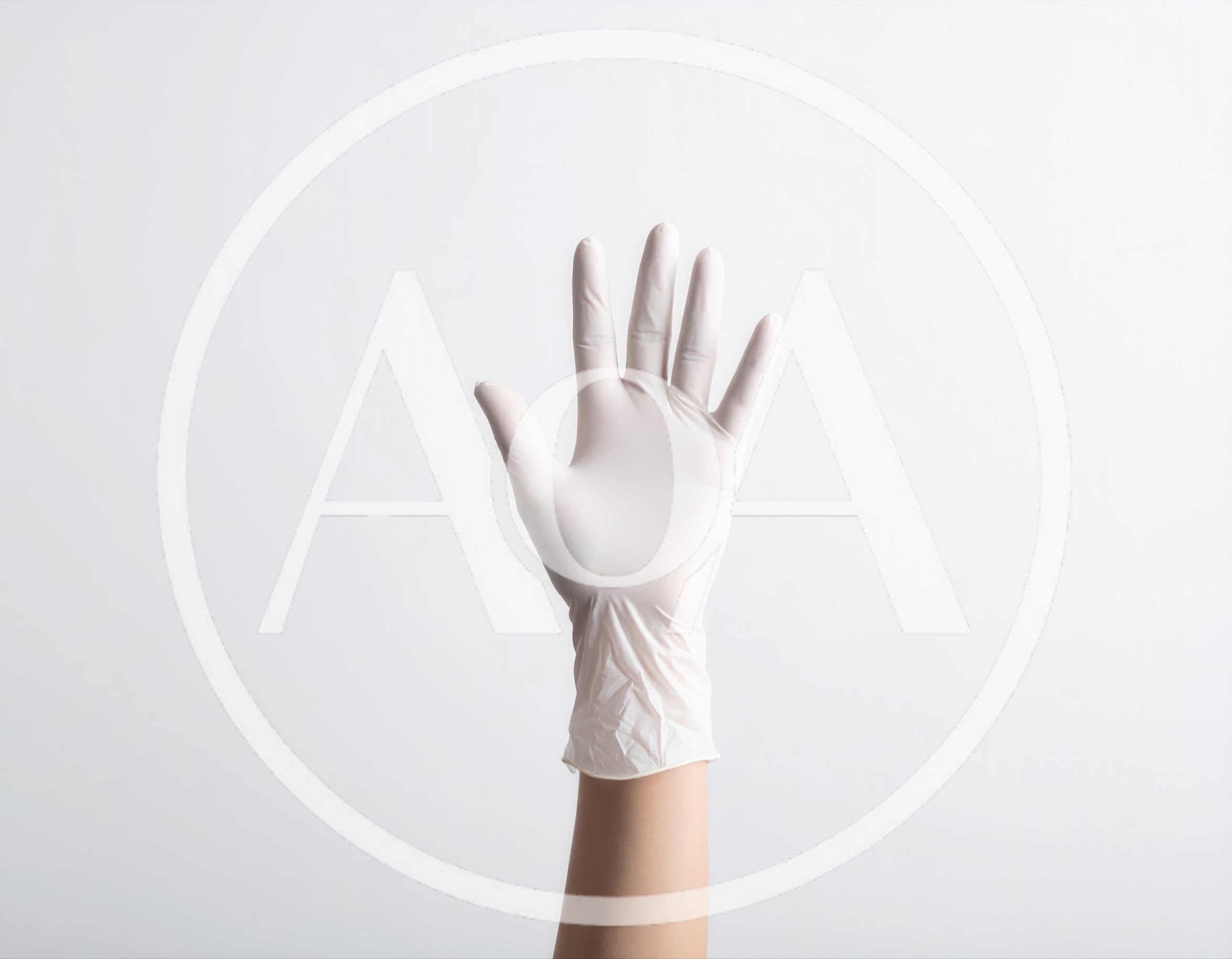 Hand Wearing A White Medical Latex Glove