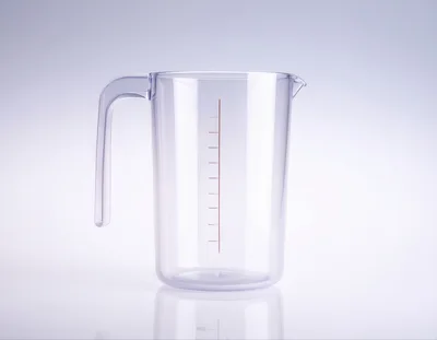 Clear Plastic Measuring Pitcher On White Background