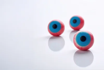 Three Realistic Eyeball Candies On White Background