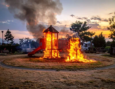 Playground Structure Engulfed in Intense Fire at Sunset