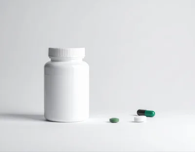 White Pill Bottle With Assorted Medication