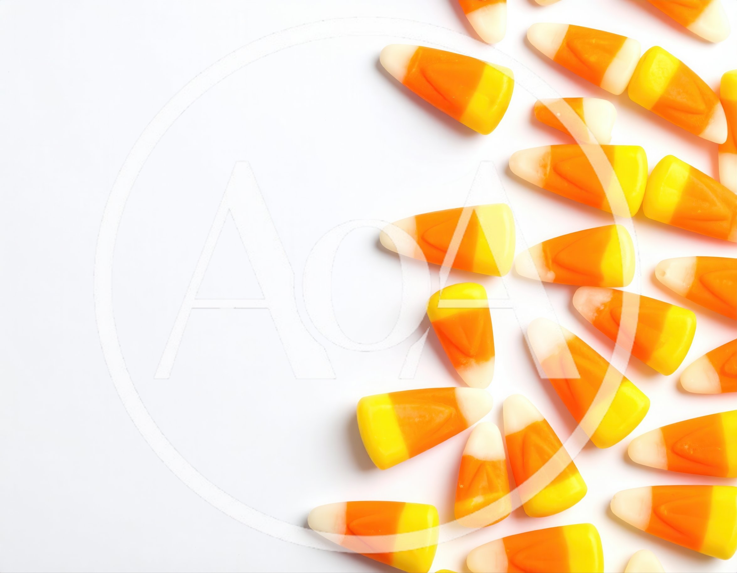 Candy Corn Pieces Scattered on White Background