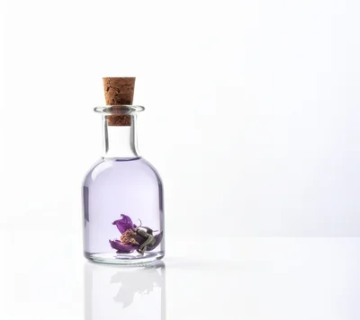 Glass Bottle With Purple Liquid And Dried Flower