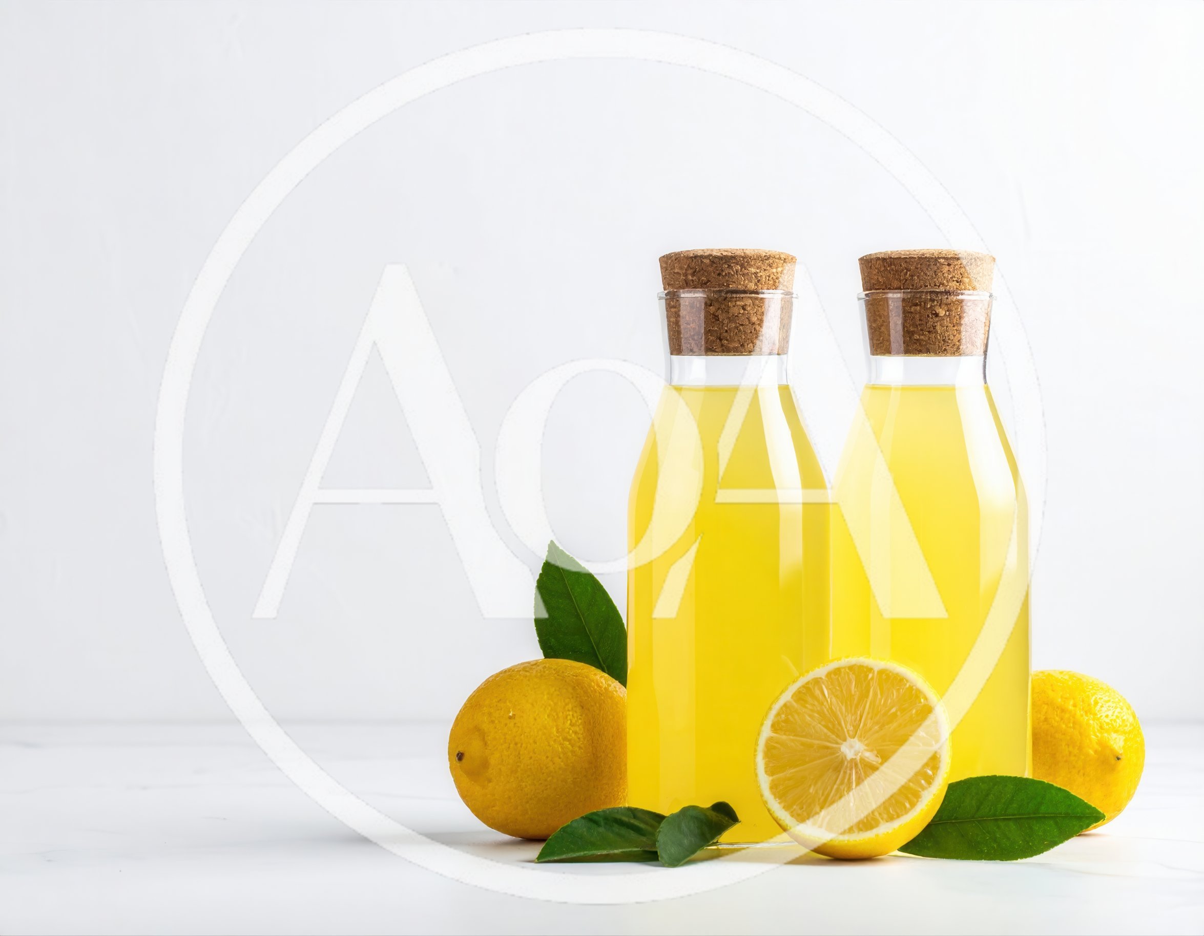 Two Bottles Of Fresh Lemonade With Whole And Sliced Lemons
