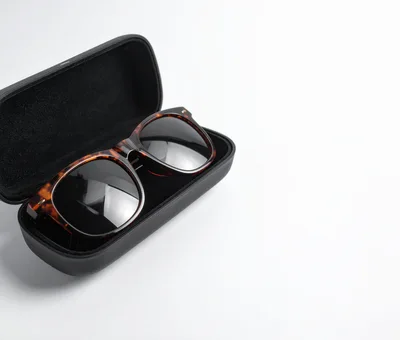 Tortoiseshell Sunglasses Resting In A Black Case