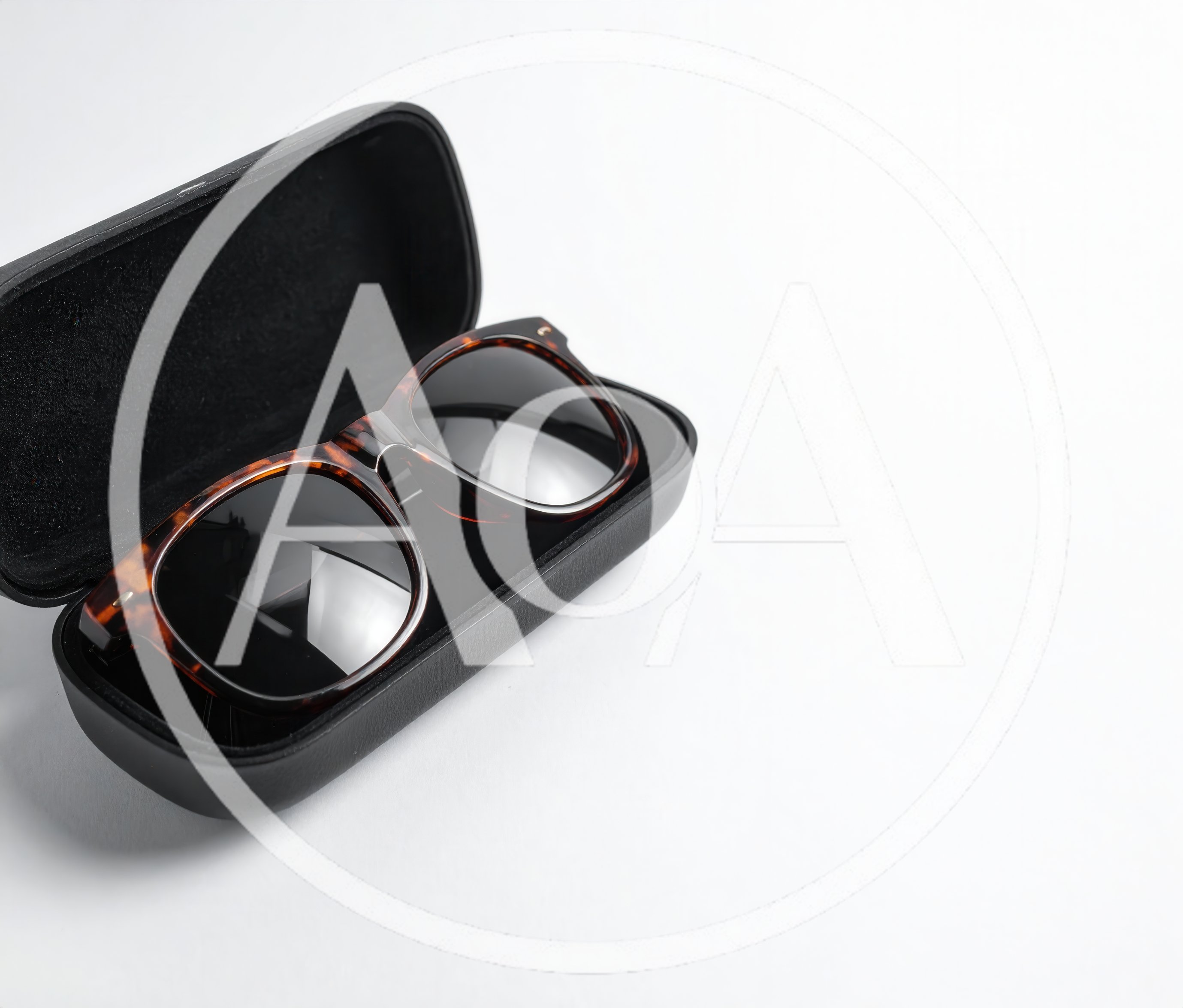 Tortoiseshell Sunglasses Resting In A Black Case
