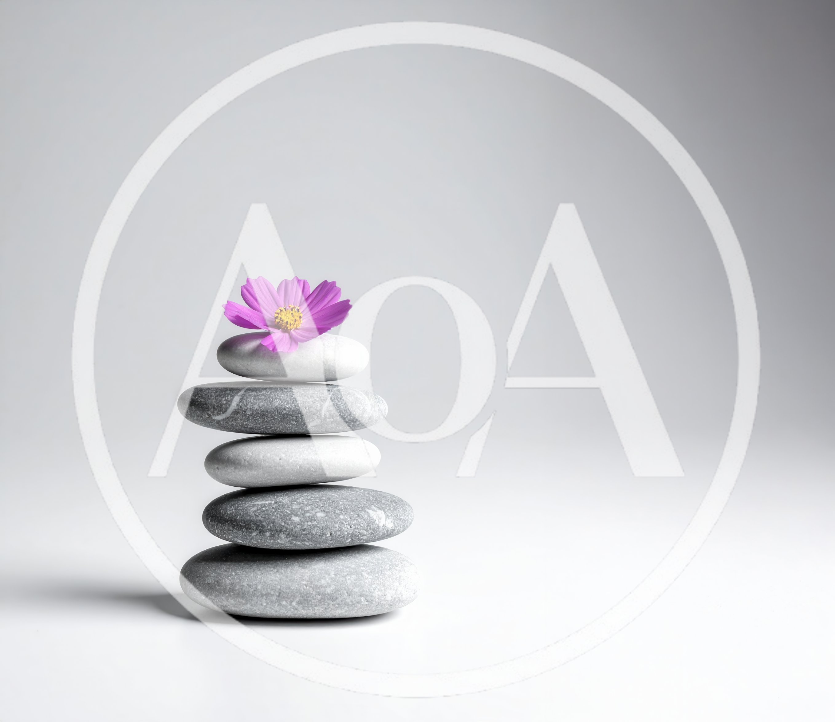 Stacked Smooth Gray Stones With A Pink Flower