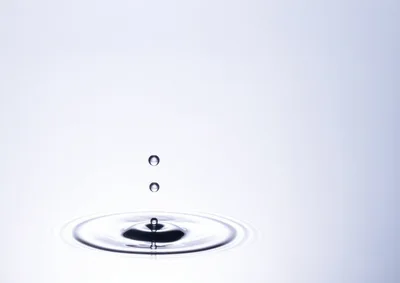 Water Droplets Falling Into A Calm Pool