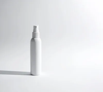 White Spray Bottle On A Plain Background