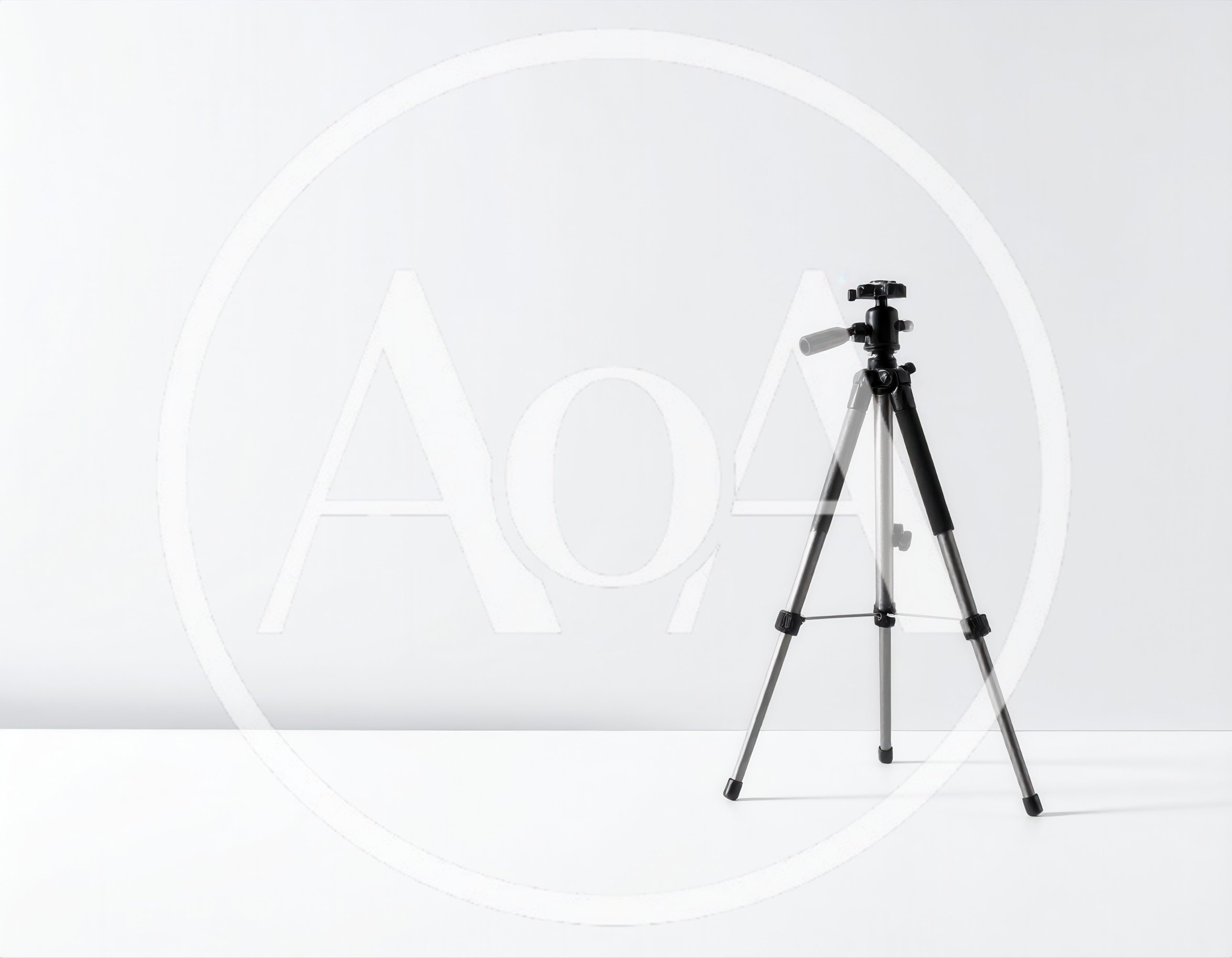 Black Camera Tripod Standing On White Surface