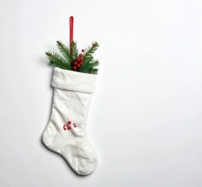 White Christmas Stocking With Pine Branches And Berries