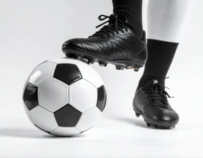 Soccer Player Standing With Foot On Ball