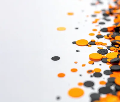 Orange And Black Halloween Confetti On White Background