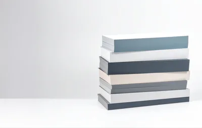 Stack Of Minimalist Books On White Surface
