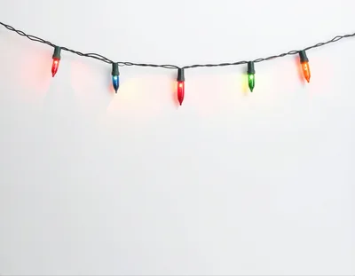 String Of Colorful Christmas Lights On White Background
