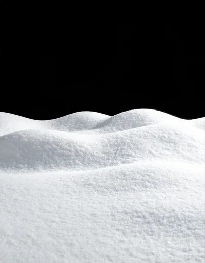 Pristine White Snow Dunes Against A Black Background