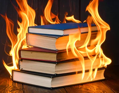 Stack of Old Books Burning on Wooden Surface