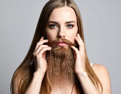 Young Woman With Long Hair And A Fake Beard